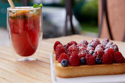 Sugar free french tart with raspberry and blueberry at the terrace. refreshing raspberry lemonade