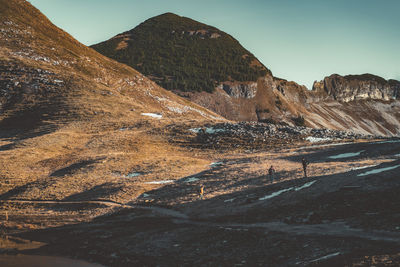 Scenic view of land and mountains against sky