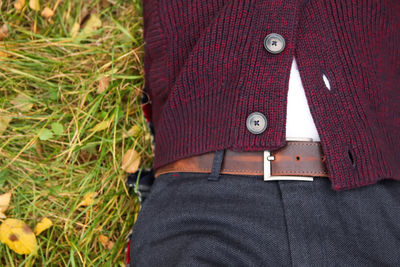 Midsection of man standing on grassy field