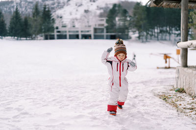 Full length of boy standing on snow