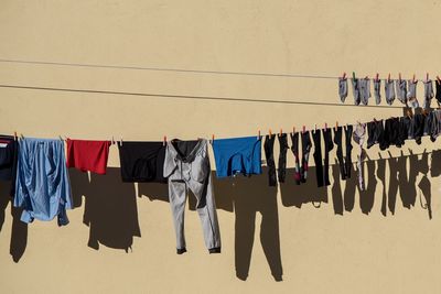 Clothes drying on clothesline against wall