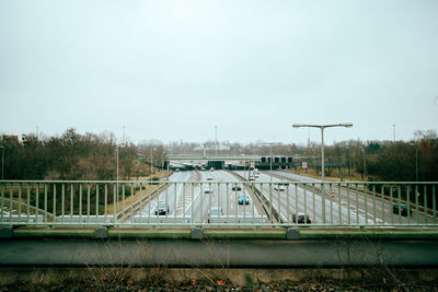 Bridge in city against clear sky