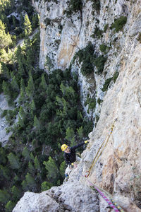 Low angle view of person on rock against mountain