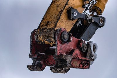 Low angle view of rusty metal against sky