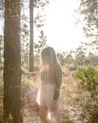 Woman standing in forest