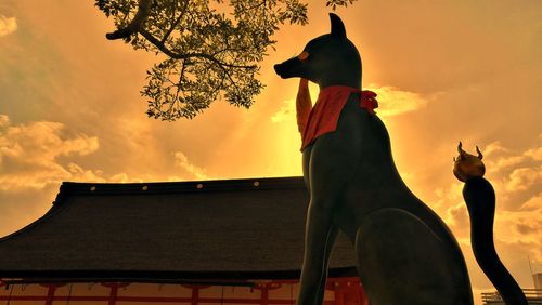 Low angle view of statue against sky during sunset