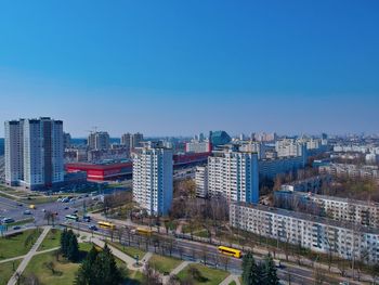 High angle view of city buildings against clear blue sky