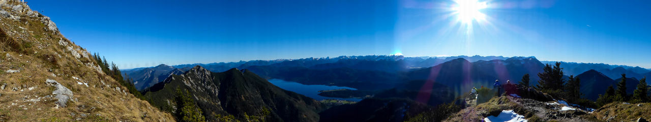 Panoramic view of mountains against blue sky