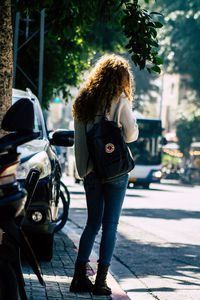 Full length of woman standing on street in city