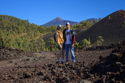 Rear view of man walking on mountain