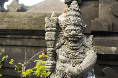 Statue of buddha against building