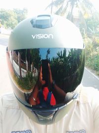 Rear view of man using mobile phone while sitting in bus