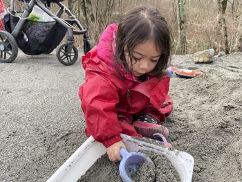 Toddler plays with sand