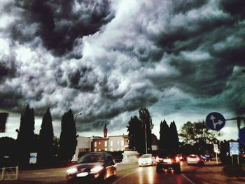 City street against cloudy sky