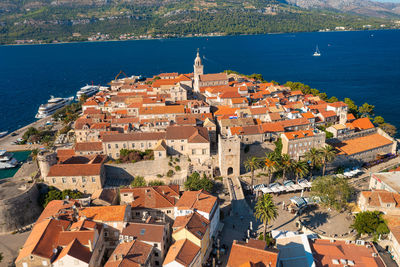 High angle view of townscape by sea