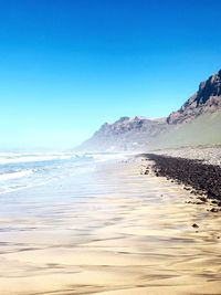 Scenic view of sea against clear blue sky