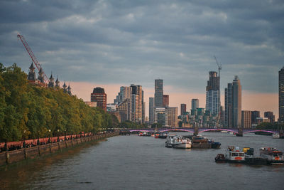 Boats in river against sky