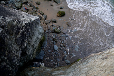 High angle view of rocks at sea shore