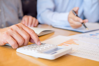 Close-up of man sitting on table