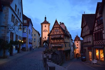 Streets amidst old houses against sky at dusk