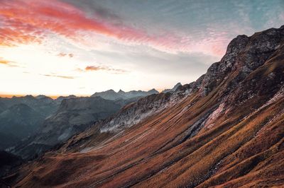 Scenic view of mountains against cloudy sky