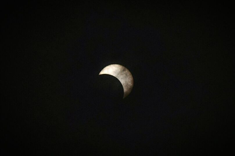 LOW ANGLE VIEW OF HALF MOON IN SKY