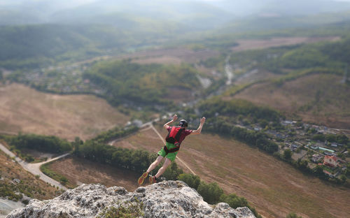 Man with arms outstretched on mountain