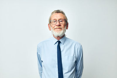 Portrait of senior man against white background