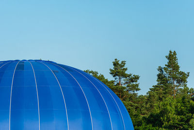 Low angle view of hot air balloon against clear blue sky