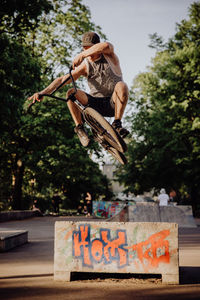 Man doing stunts with bicycle against trees