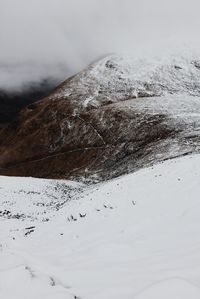 Close-up of snow covered mountain against sky