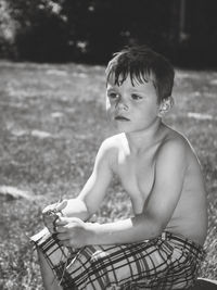 Cute boy sitting outdoors