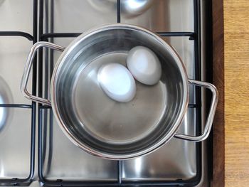 Close-up of boiled eggs in container at kitchen