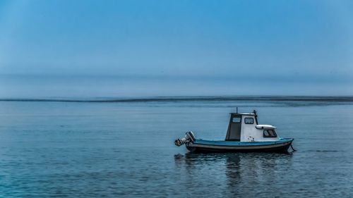 Boat in sea against blue sky