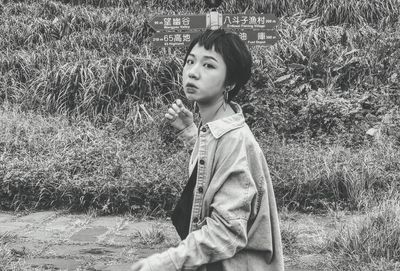 Portrait of girl looking away on field