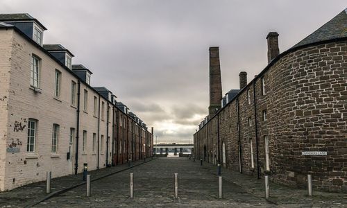 Street amidst buildings in city against sky