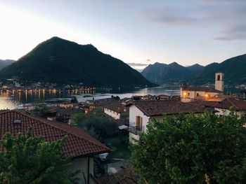 Houses by sea against sky in town