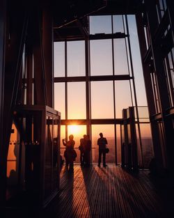 Silhouette people standing in shard london bridge during sunset