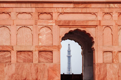 Tower seen through arch of historical building