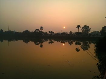 Scenic view of lake against sky during sunset