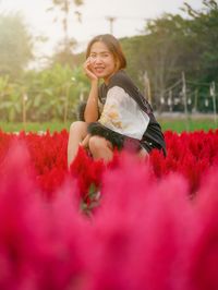 Woman wearing red flower on field
