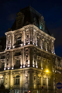 Low angle view of illuminated cathedral against sky at night