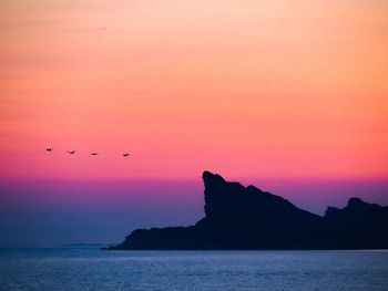 Scenic view of sea against orange sky