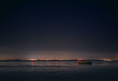 Scenic view of sea against sky at night