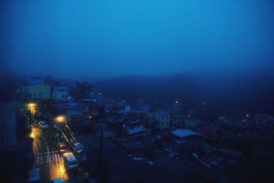 High angle view of illuminated buildings in city at night