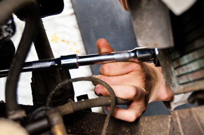 Close-up of hand holding bicycle