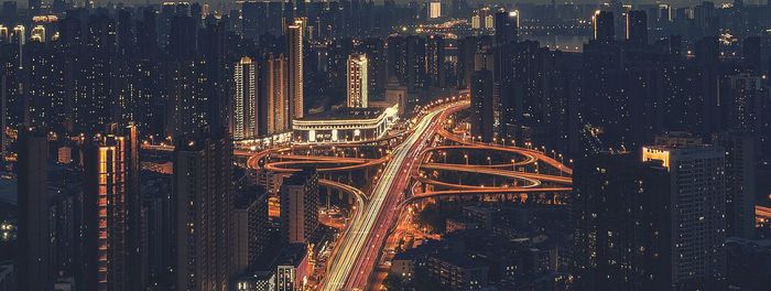 High angle view of illuminated buildings in city at night