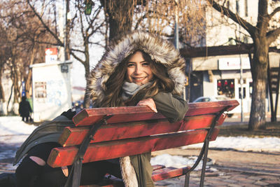 Portrait of woman on snow covered city in winter