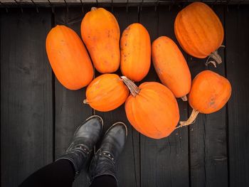 Low angle view of orange pumpkins on wooden floor