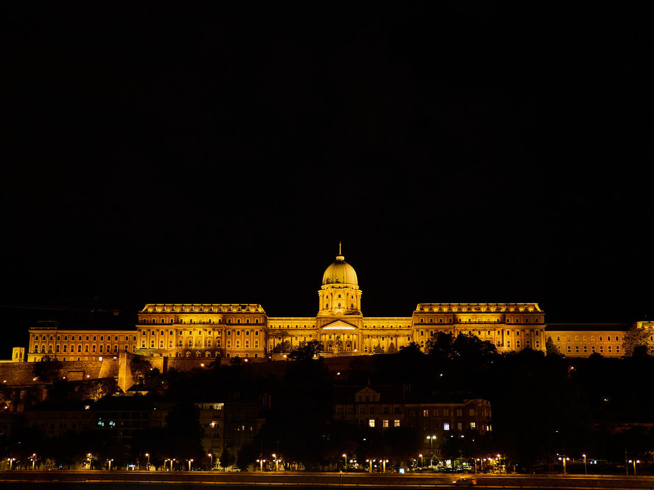 ILLUMINATED BUILDINGS IN CITY AT NIGHT